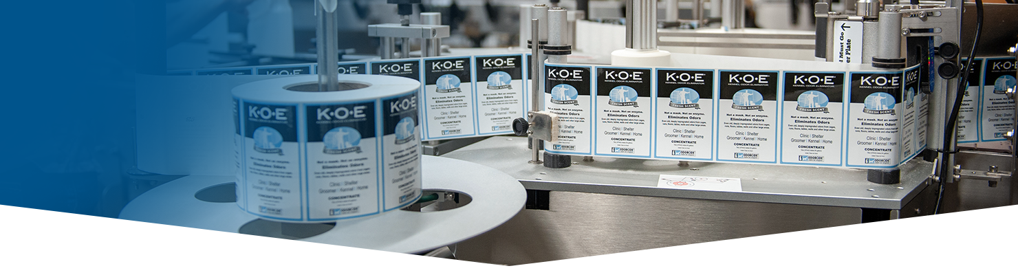 Kennel Odor Eliminator (K.O.E.) labels on the bottle labeling line at the Odorcide plant,